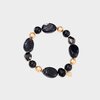 Elastische armband met zwarte glaskralen en vier gouden tussenkralen 18,5 cm